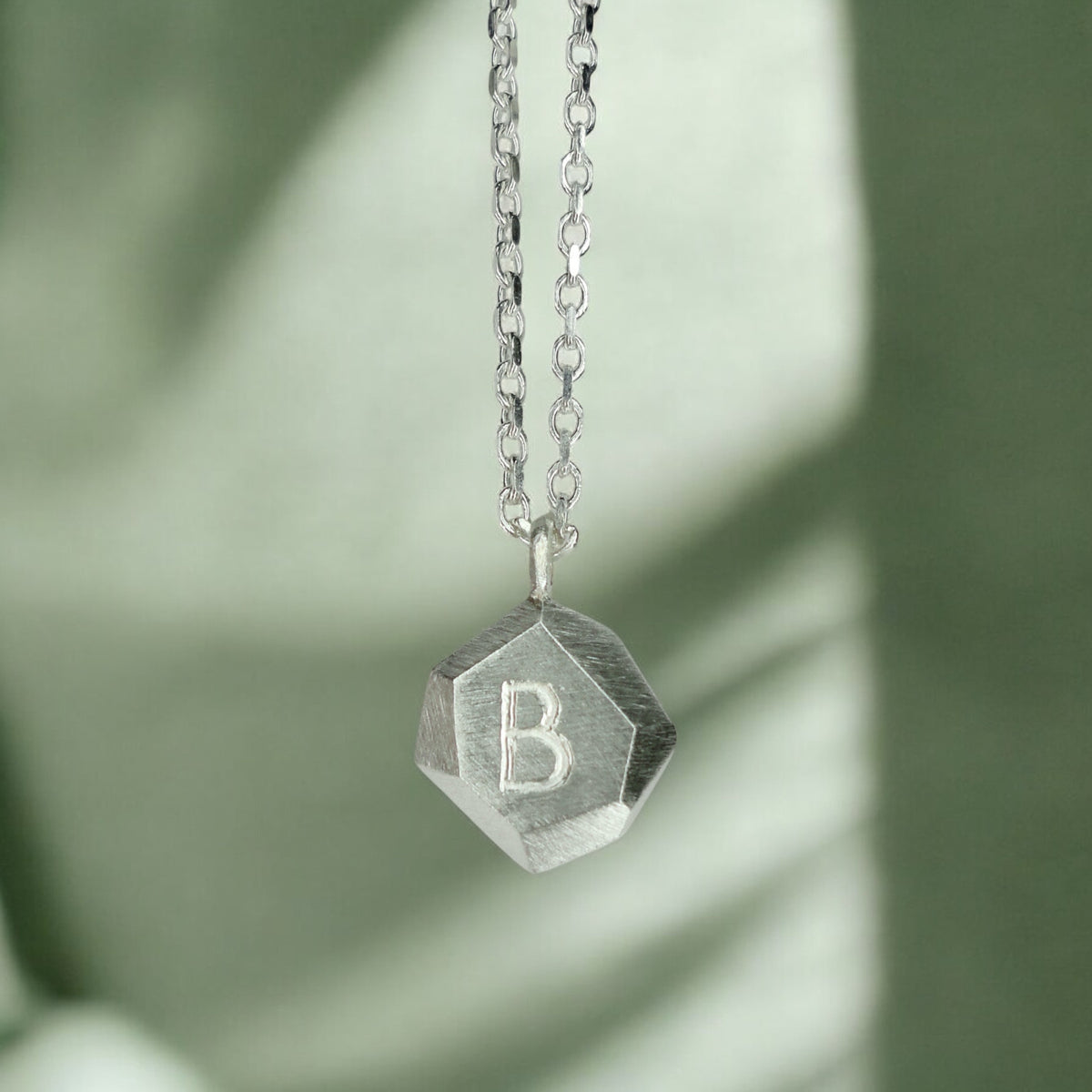 Custom-made engraved geometric initial pendant necklace in sterling silver