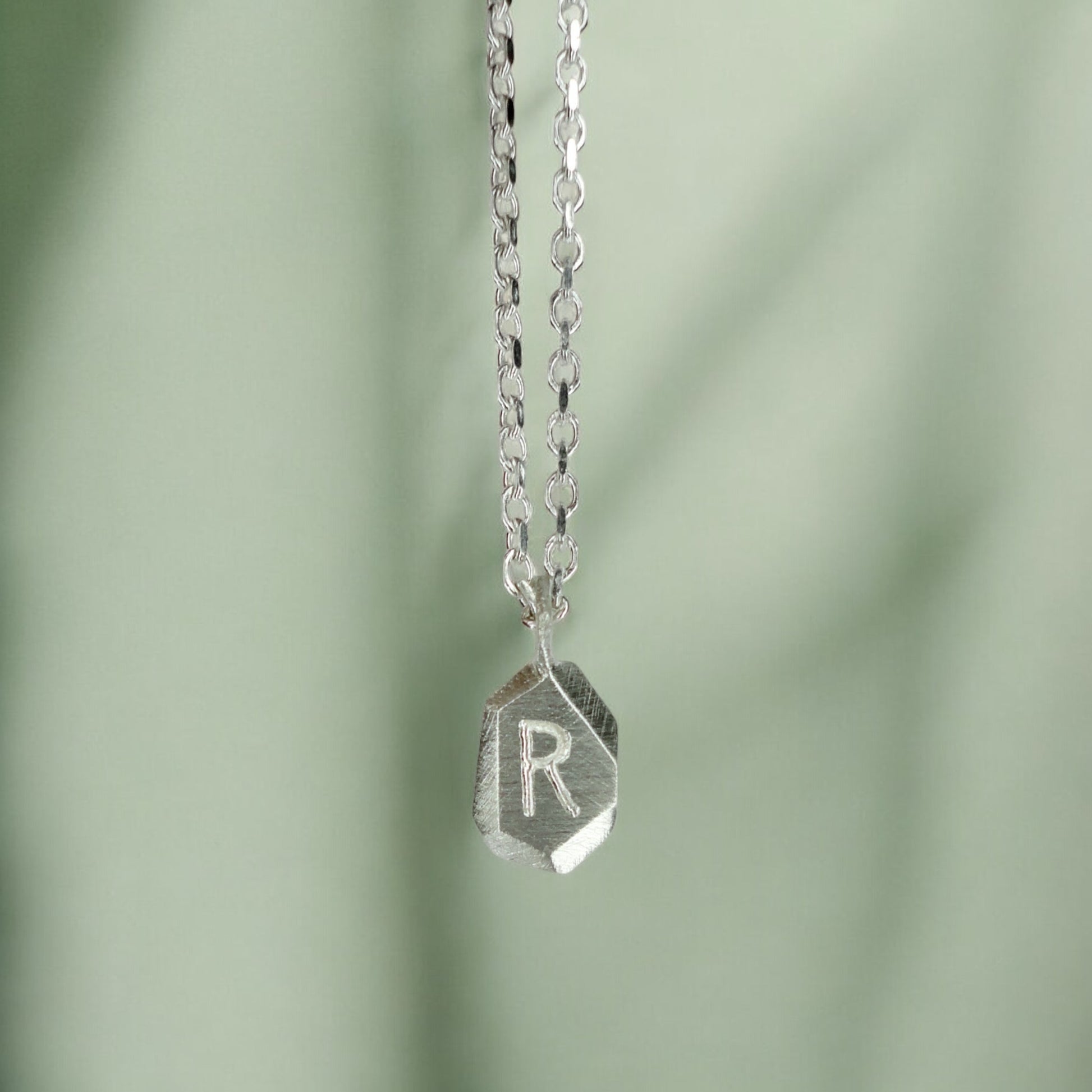 Custom-made engraved geometric initial pendant necklace in sterling silver