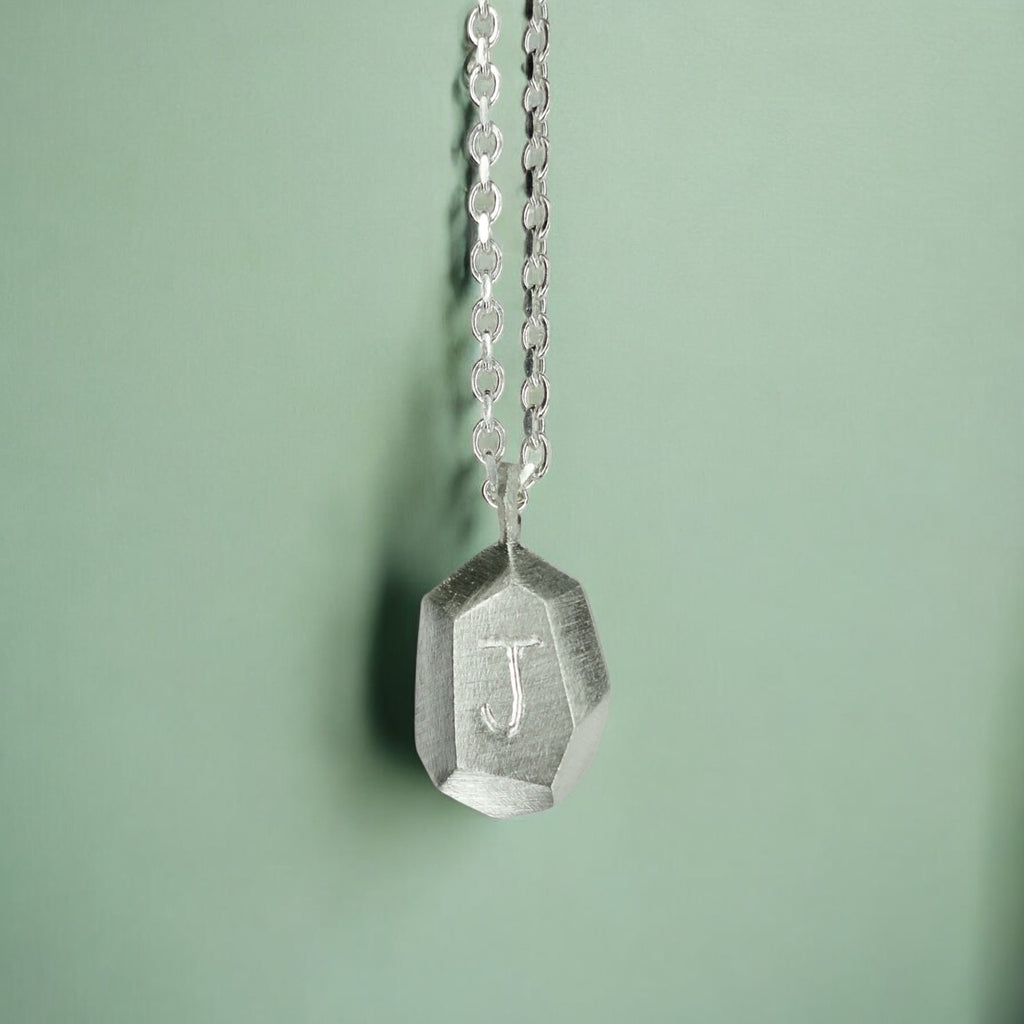 Custom-made engraved geometric initial pendant necklace in sterling silver