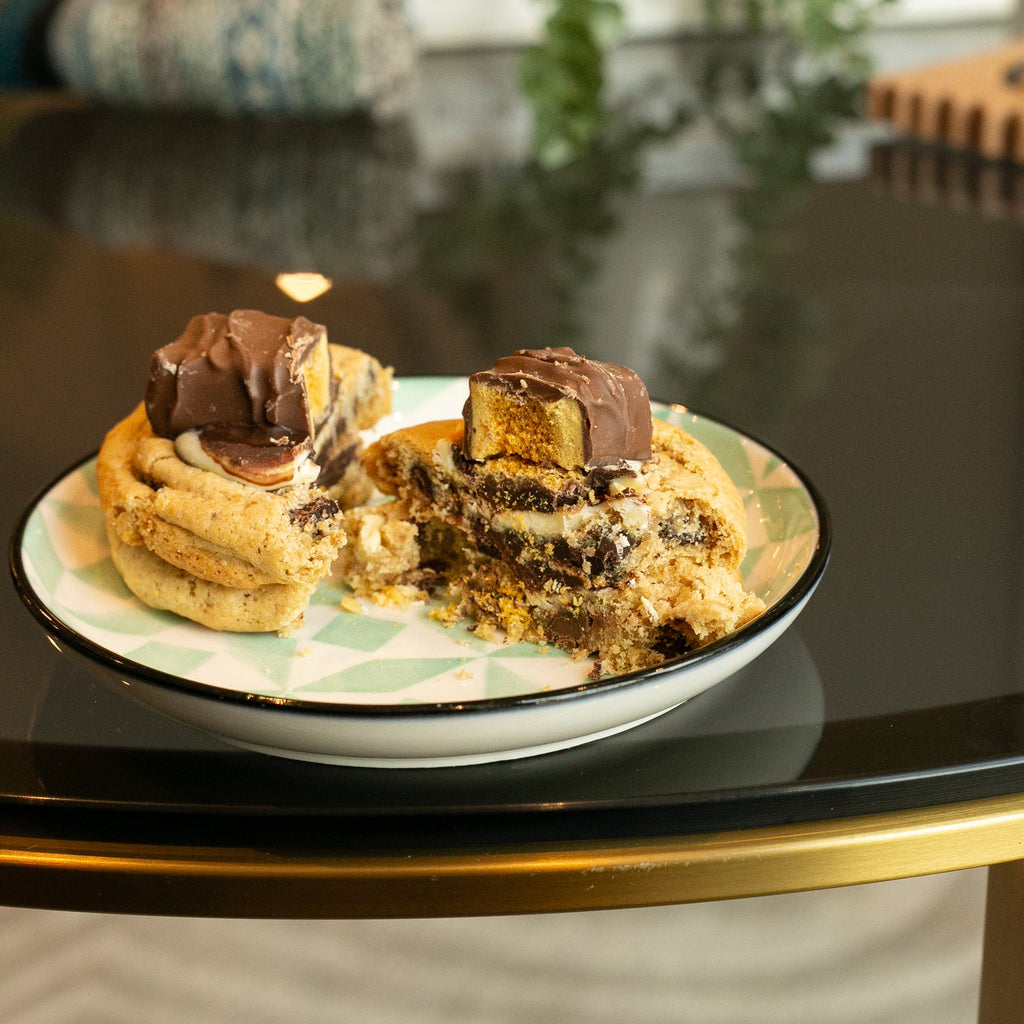 A large cookie cut into two pieces on a plate