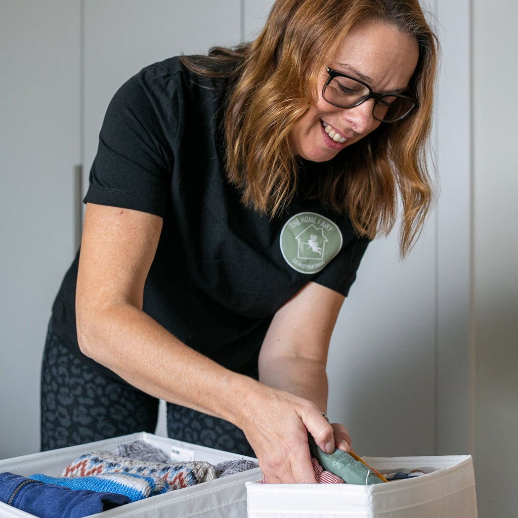 Woman organizing items in a box indoors