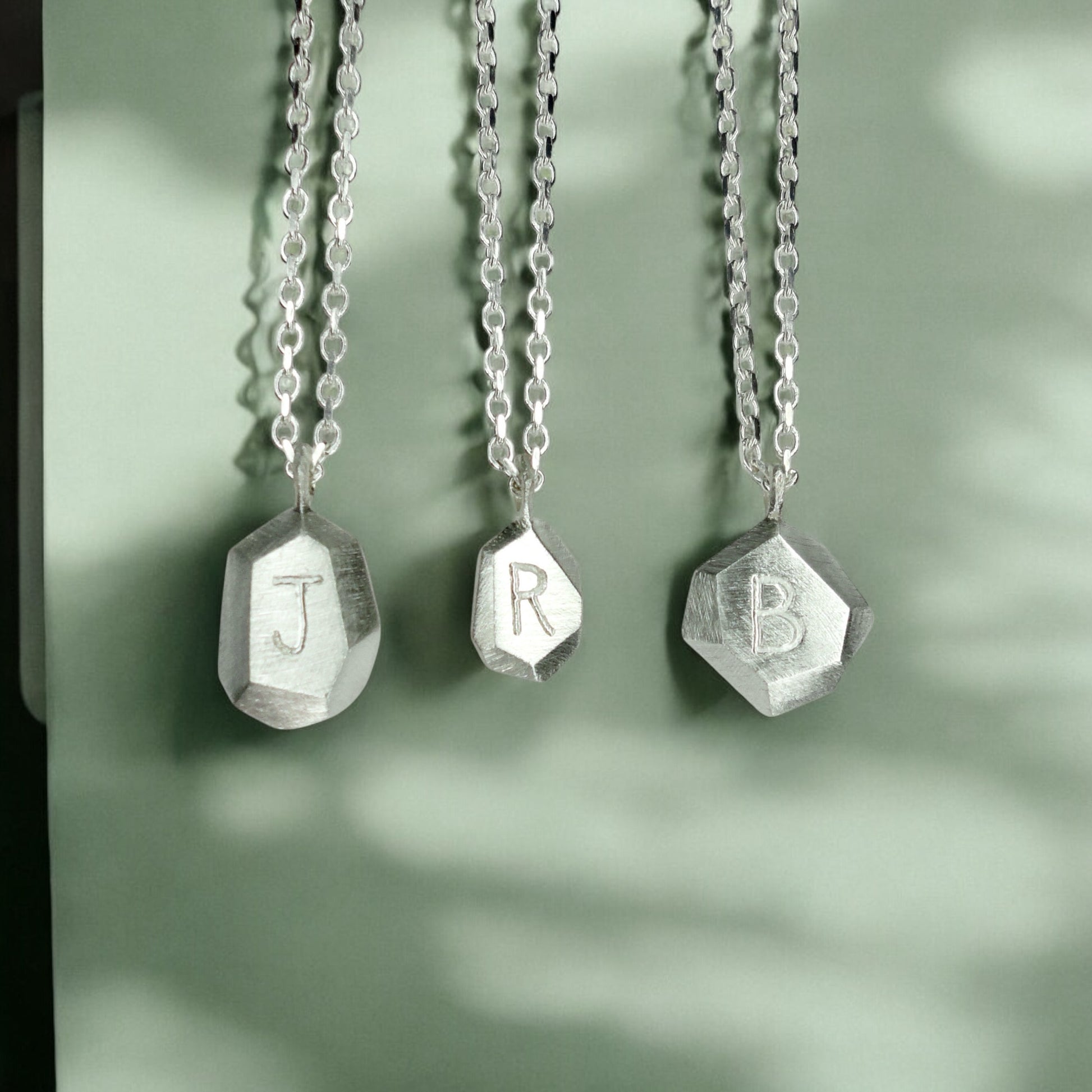 Custom-made engraved geometric initial pendant necklace in sterling silver